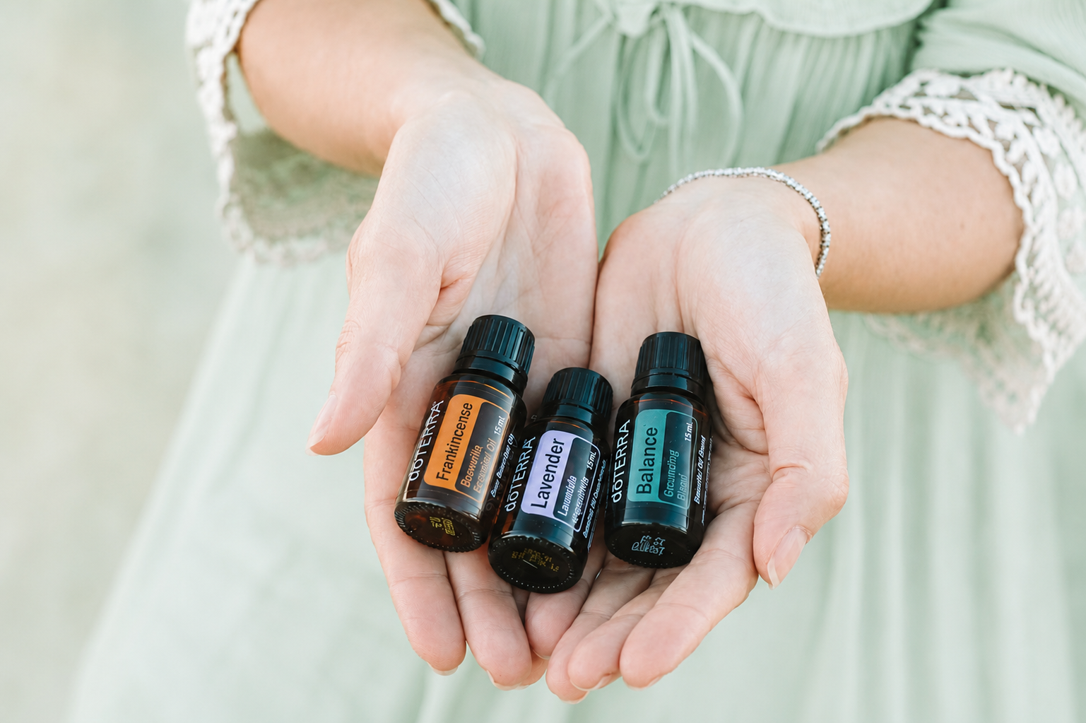 Hands cradling an essential oil bottle